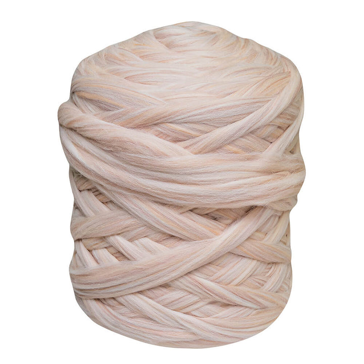 A big ball of seashell color chunky wool yarn for arm knitting
