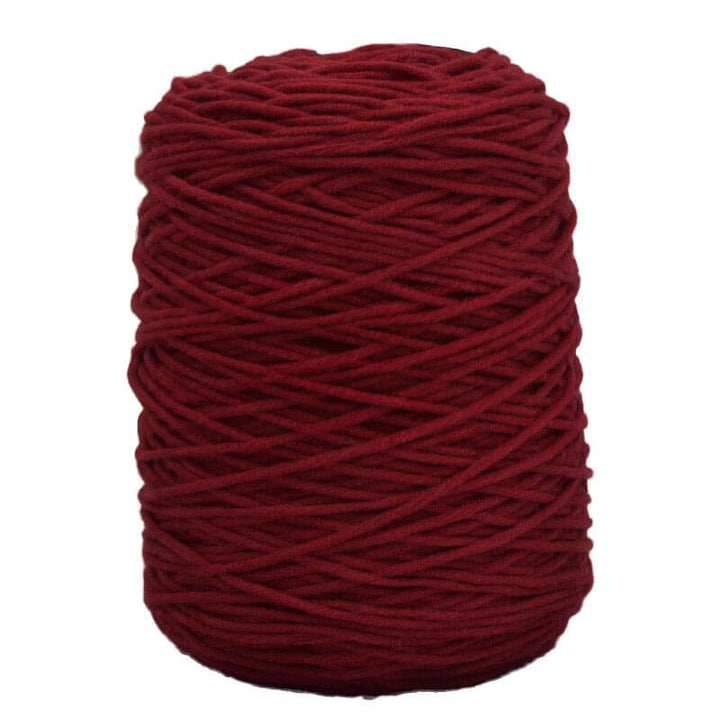 Red acrylic tufting yarn on a white background