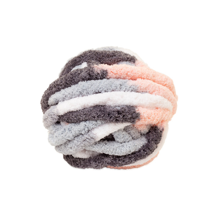 Stack of multicolored thick chenille yarn on a white background