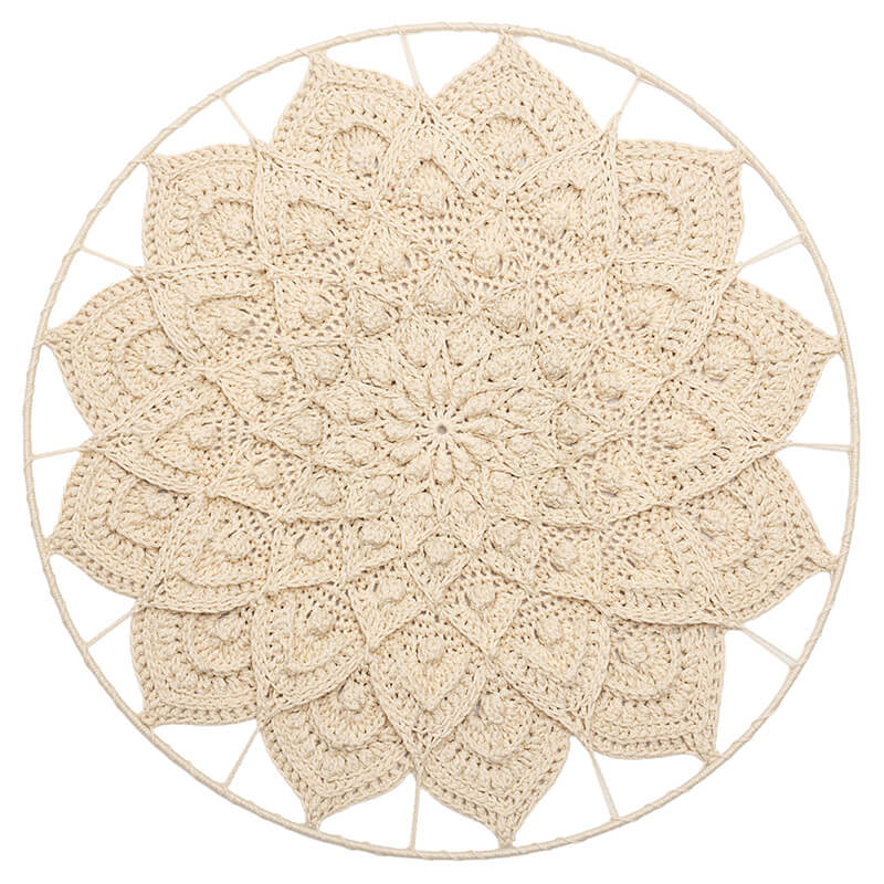 Round beige crocheted doily 3d mandala on a white background