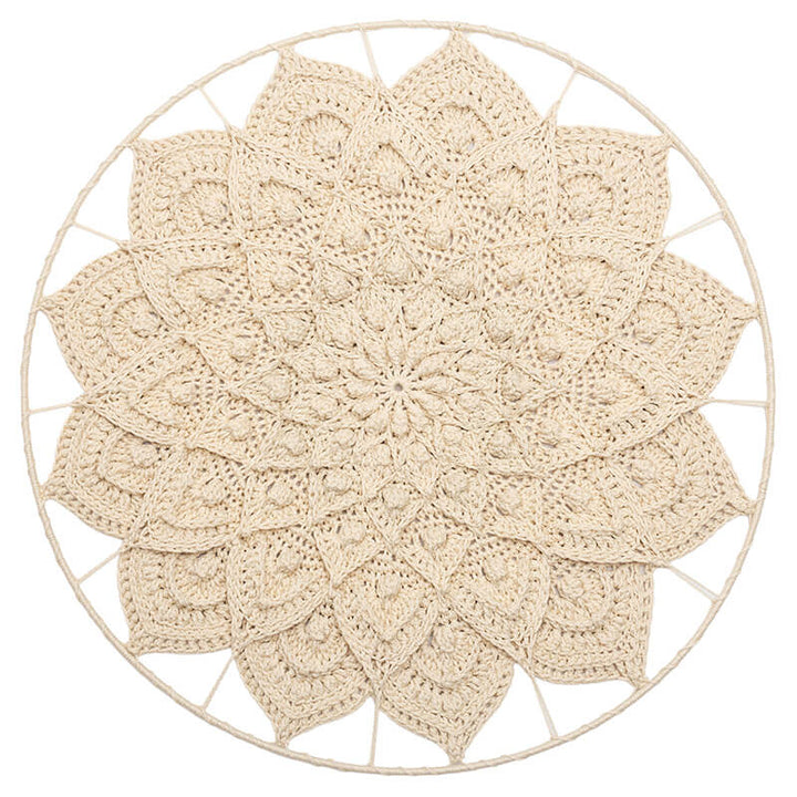 Round beige crocheted doily 3d mandala on a white background
