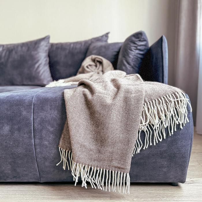 brown woven wool throw on draped on sofa in living room