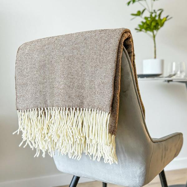 brown merino wool throw folded on the chair