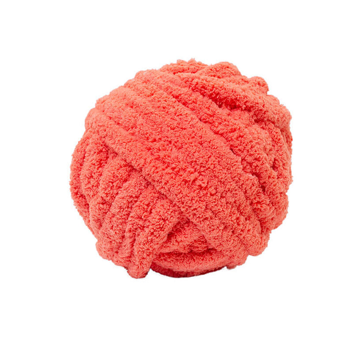 Coral-colored chunky chenille yarn on a white background