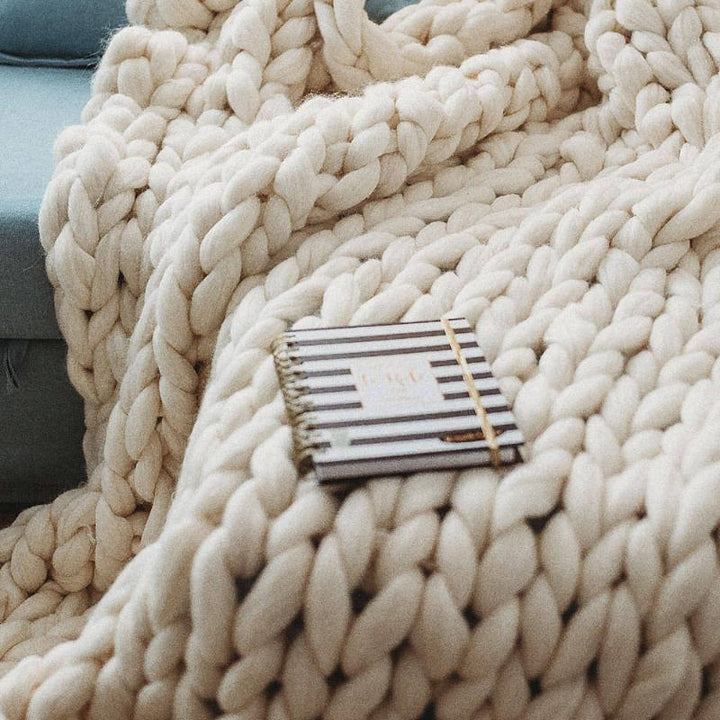 Full size chunky knit blanket on a sofa 