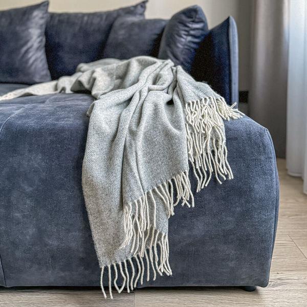 light grey woven wool blanket on couch in living room