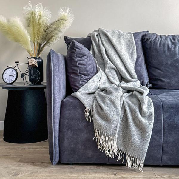 light grey woven merino wool blanket on a couch