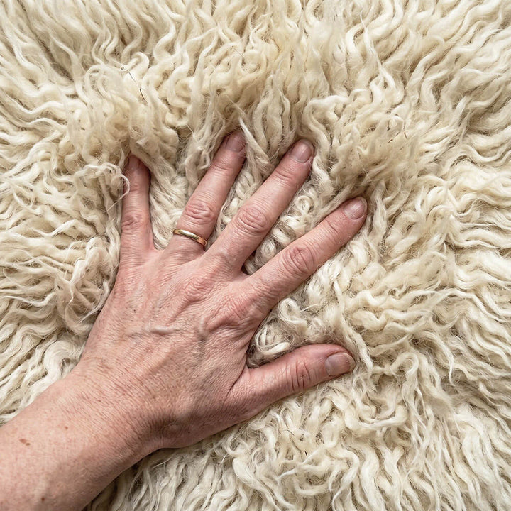 Hand touching a fluffy white surface