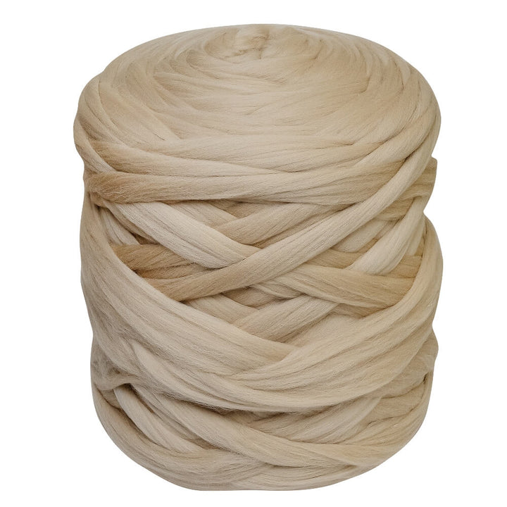 a ball of merino wool yarn in dirty beige