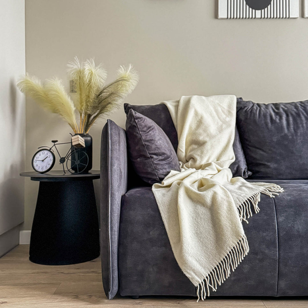 off white woven wool blanket in couch in living room