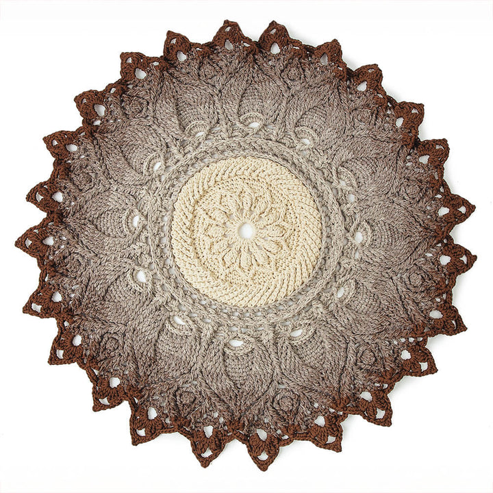 Round crochet doily with brown and beige colors on a white background