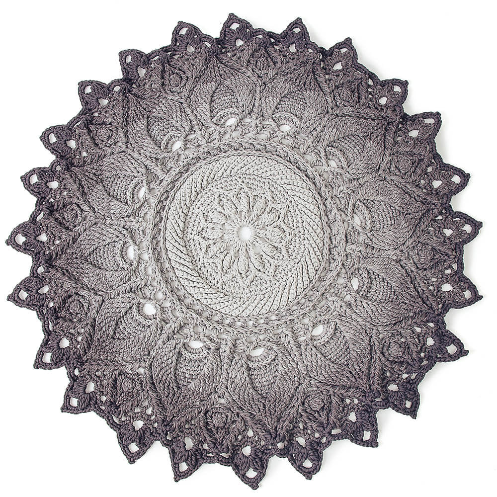 Crocheted doily with intricate patterns on a white background