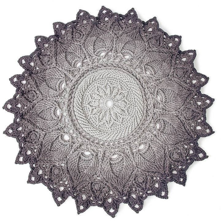 Crocheted doily with intricate patterns on a white background