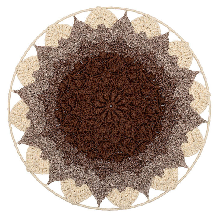 Round crochet wall hanging with a brown center and beige border on a white background