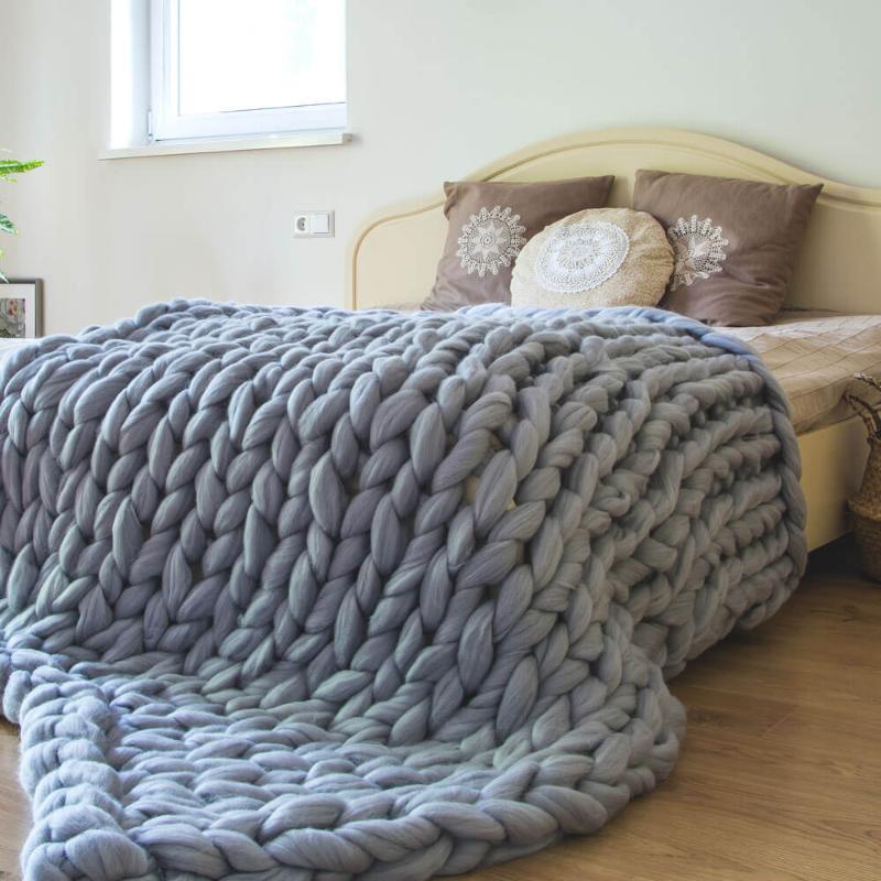 queen size grey chunky knit blanket on the bed