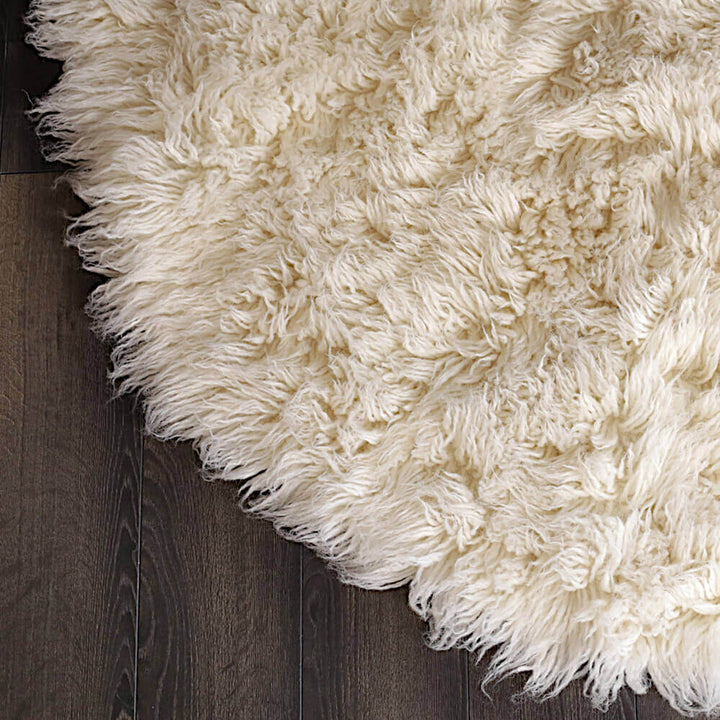 Close-up of a fluffy white rug on a wooden floor