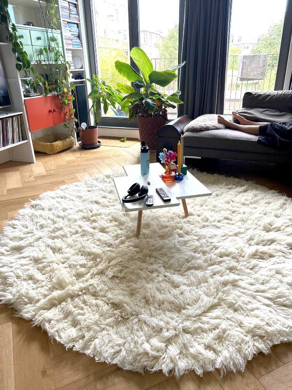 White round flokati rug in a living room